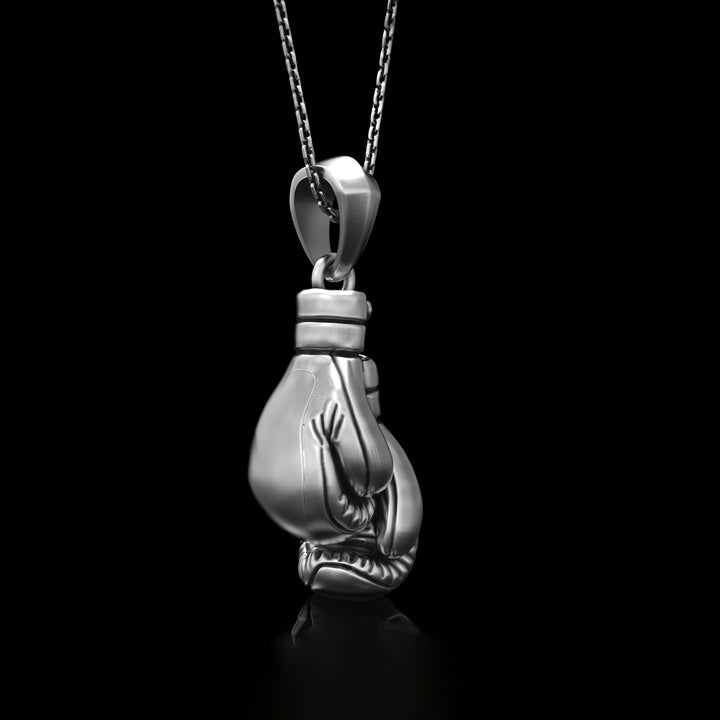 Sterling silver fighter necklace on a black background