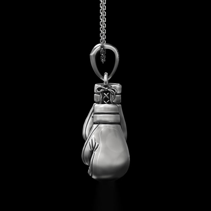 Silver boxing fan necklace against a black background