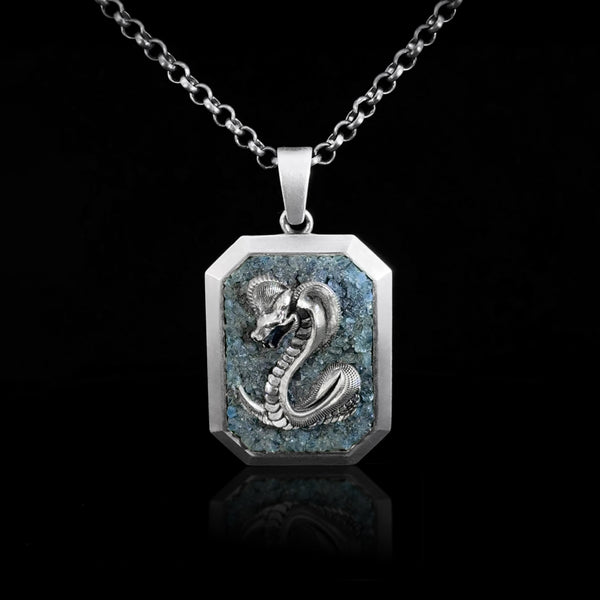 Sterling silver pendant with cobra design and blue mosaic stones inlay on a black background