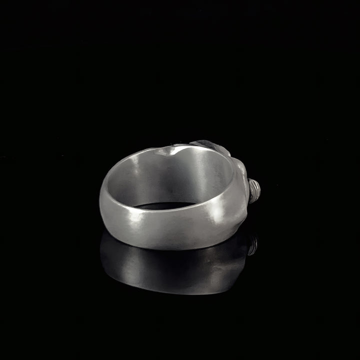 Silver band ring on a black background