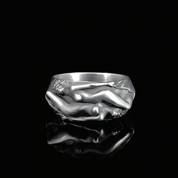 Silver ring with a unique lesbian couple design on a black background