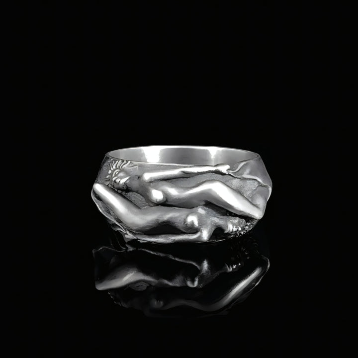 Silver ring with a unique lesbian couple design on a black background