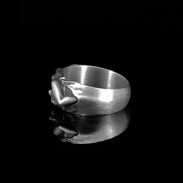 Silver ring with a unique lesbian pride design on a black background