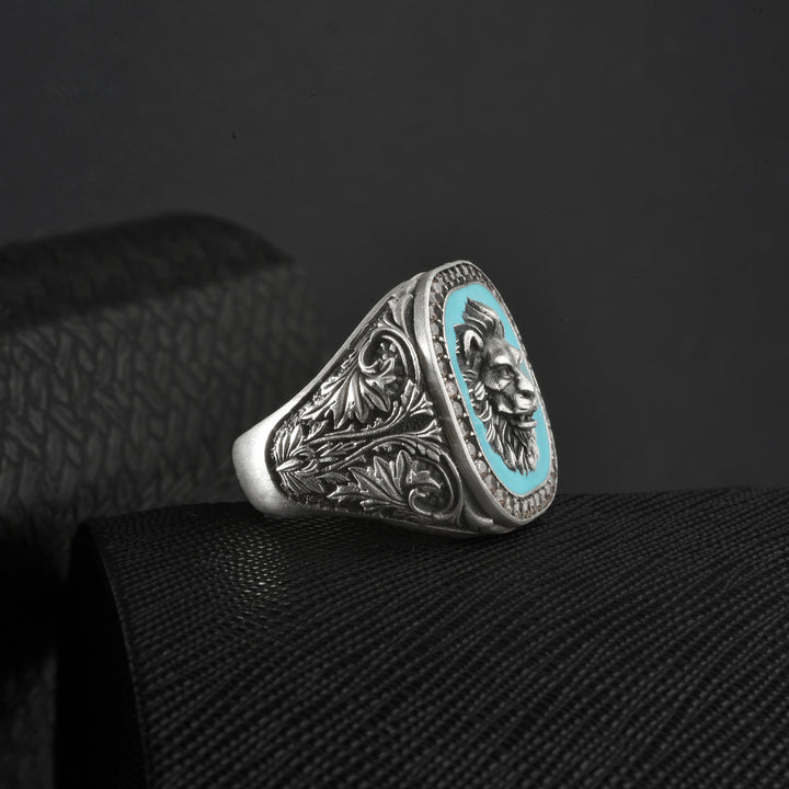 Sterling silver ring with intricate artdeco shank design and turquoise center on a black background