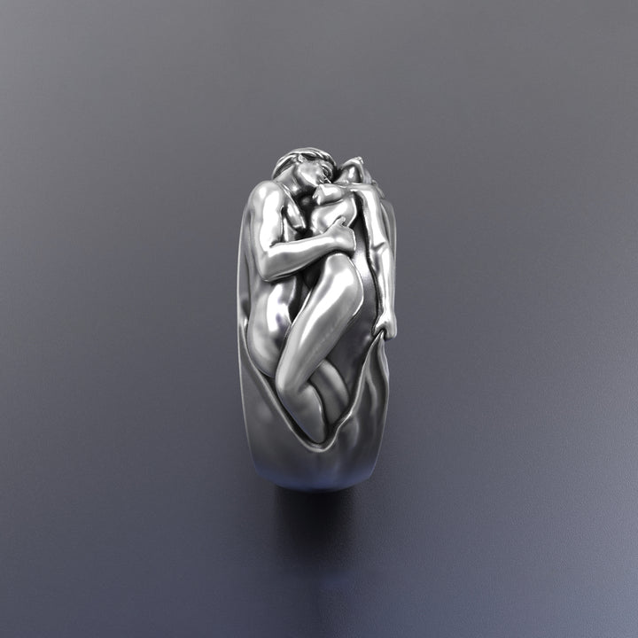 Silver love band ring with a detailed design on a dark gray background