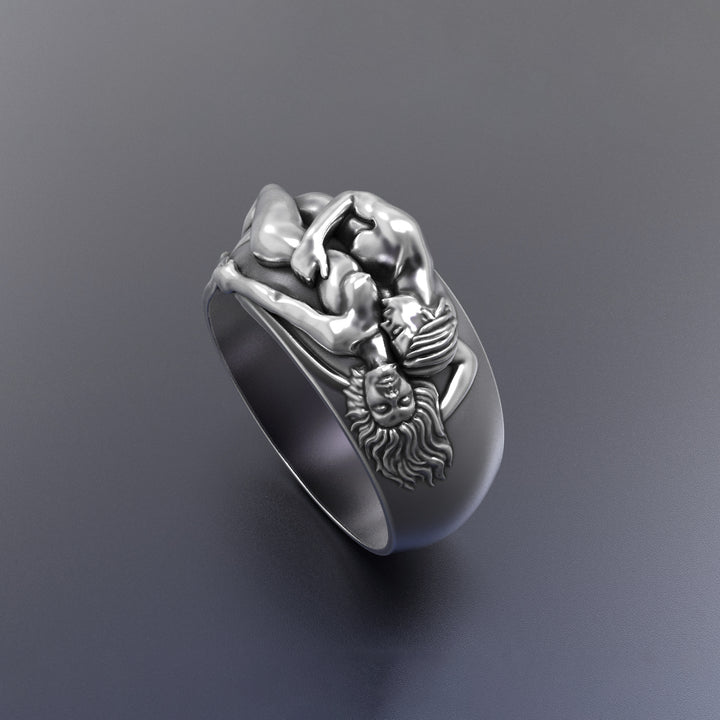 Silver ring with intricate romantic design on a dark gray background