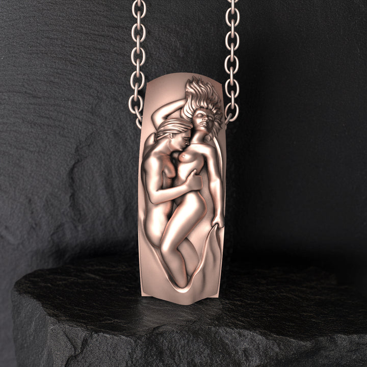 Bronze pendant with intimate lovers design on a dark background